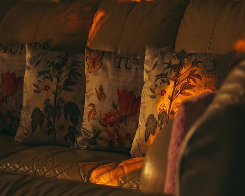 A cozy living room at night with dim, warm lighting